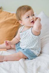 Baby boy wearing Avauma blue picot tank set – white sleeveless top with blue trim and matching blue shorts